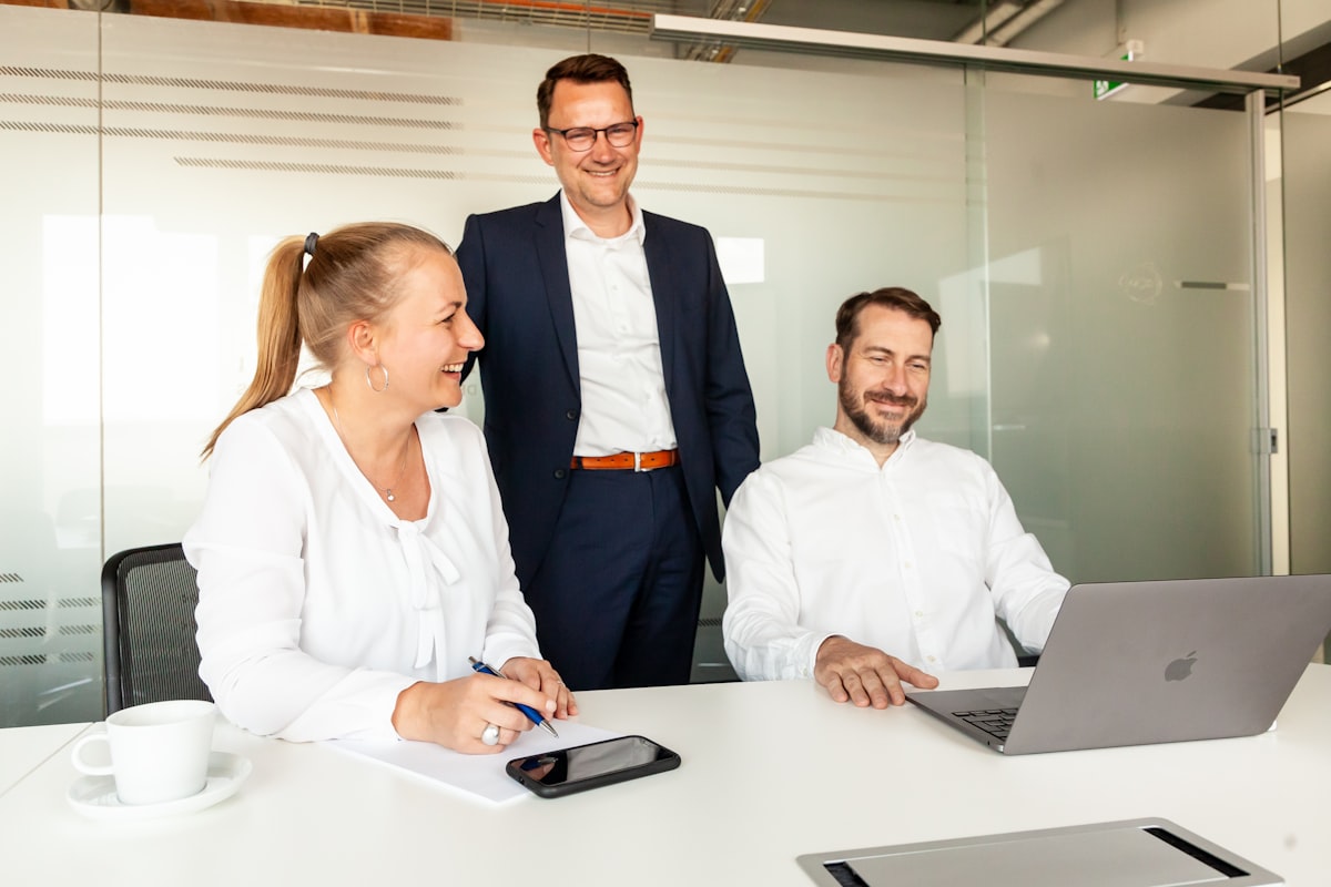 A team collaborating around a laptop