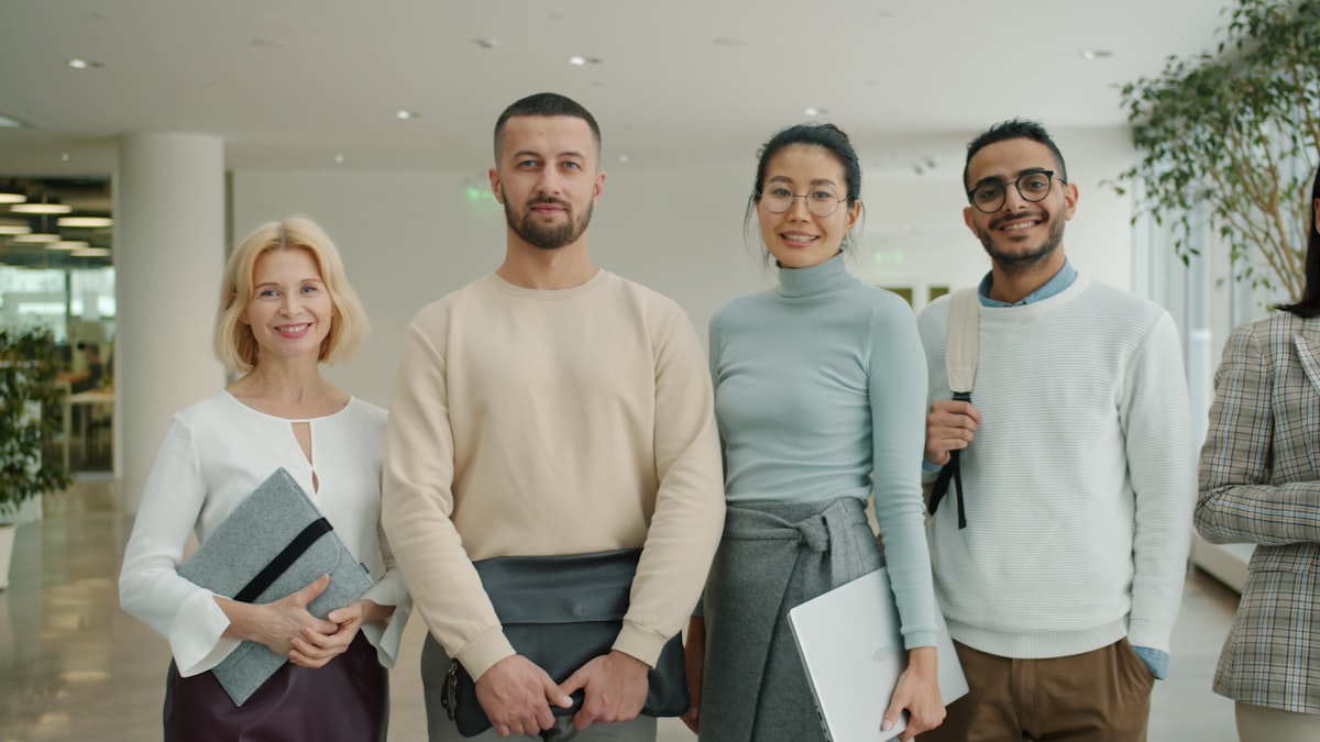 Colleagues talking in an office hallway